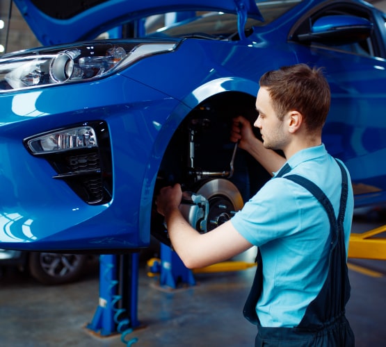 Auto body technician performing collision repair on a damaged vehicle frame in Philadelphia